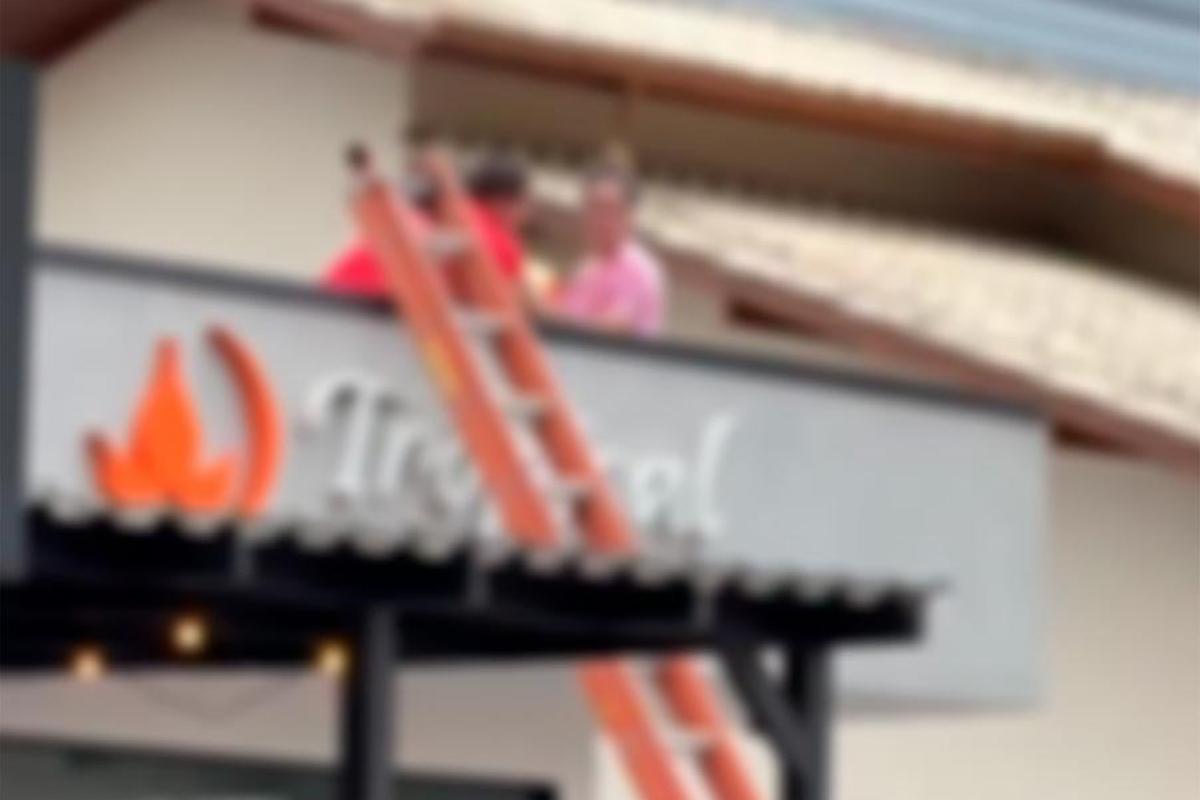 Mulher nua sobe em telhado de padaria e tenta se jogar